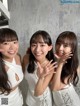 A group of three young women posing for a picture.