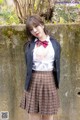 A woman in a school uniform posing for a picture.