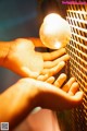 A person holding a light bulb in their hand.