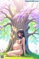 A pregnant woman sitting under a tree in the grass.